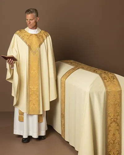 Priest in liturgical vestments standing next to an altar with a brown background